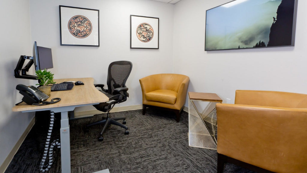 Sit Stand Desk by office chairs and TV